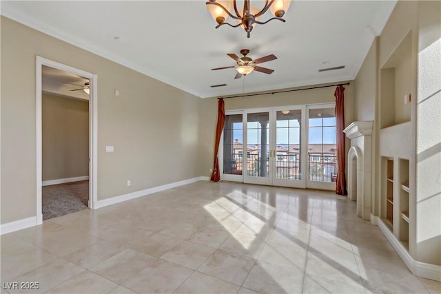 empty room featuring light tile patterned flooring and ceiling fan with notable chandelier