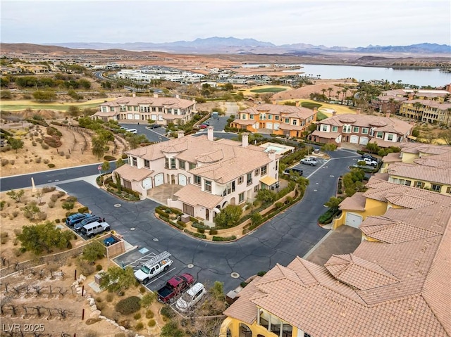 drone / aerial view featuring a water and mountain view