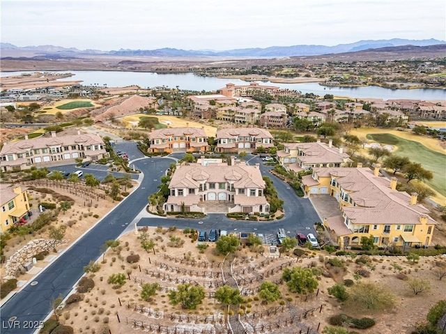 birds eye view of property with a water and mountain view