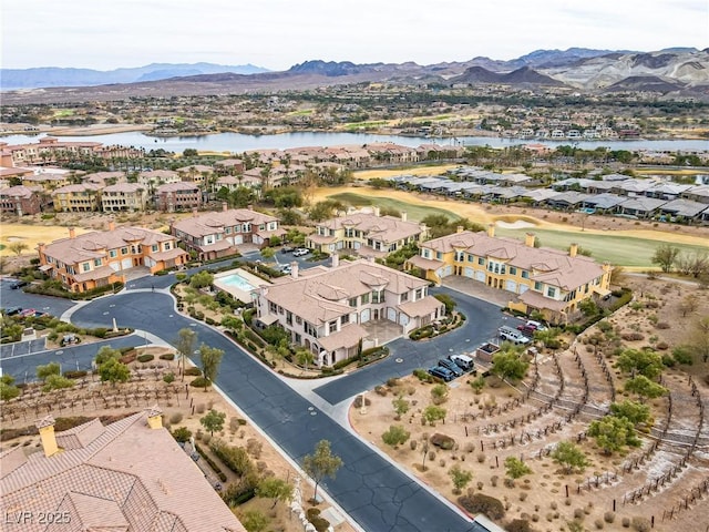 drone / aerial view featuring a water and mountain view