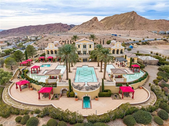 view of swimming pool with a mountain view and a patio