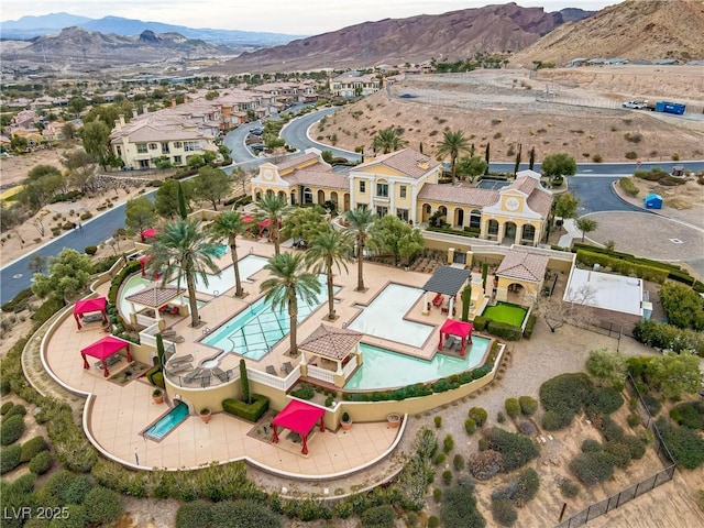 birds eye view of property with a mountain view