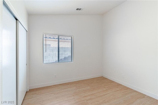 4507 Golden Palomino Ln, North Las Vegas, NV 89032 - unfurnished bedroom featuring light wood-style flooring, a closet, and baseboards