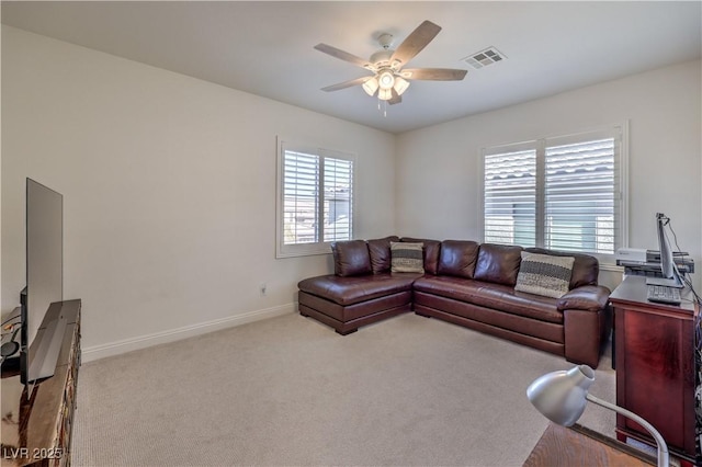 carpeted living room with ceiling fan