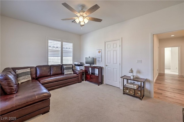 living room featuring light carpet and ceiling fan