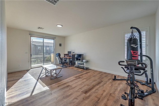 exercise room with hardwood / wood-style flooring