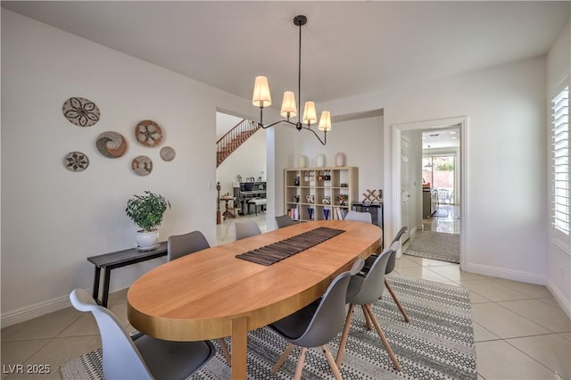 tiled dining space featuring a chandelier