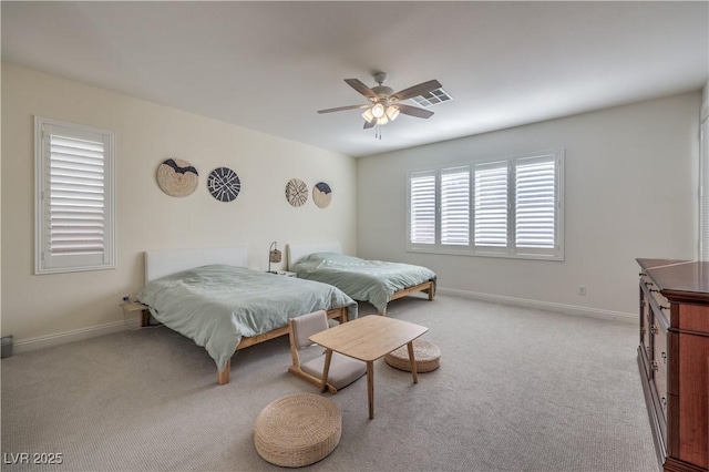 bedroom with ceiling fan and light carpet