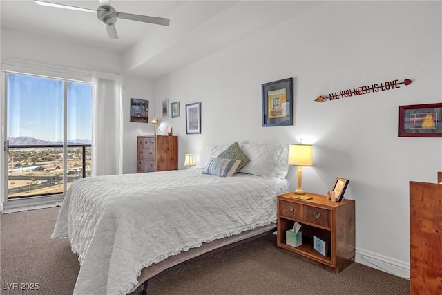 carpeted bedroom featuring ceiling fan and a mountain view