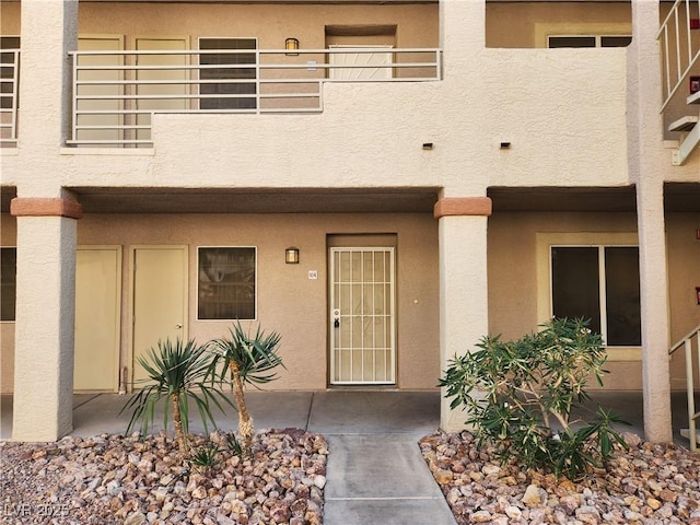 doorway to property with a balcony and a patio