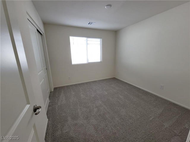 empty room with dark carpet