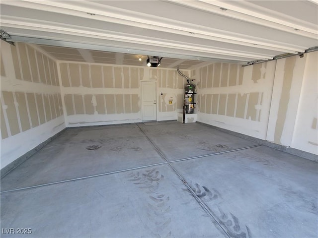 garage with a garage door opener and gas water heater