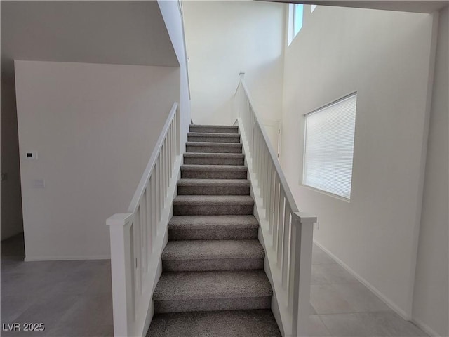 staircase with a towering ceiling