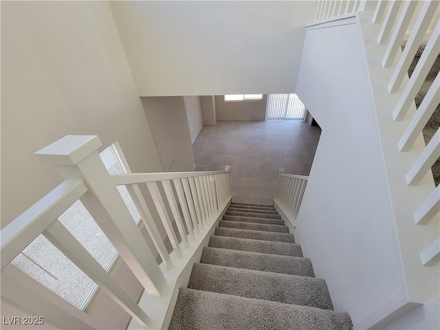 staircase with a towering ceiling