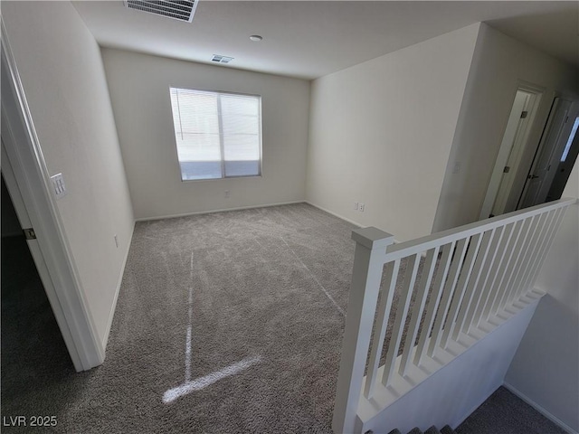 unfurnished room featuring carpet