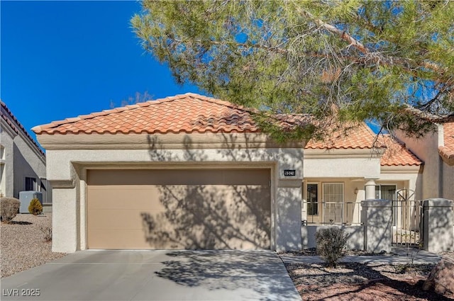 mediterranean / spanish-style home with a garage