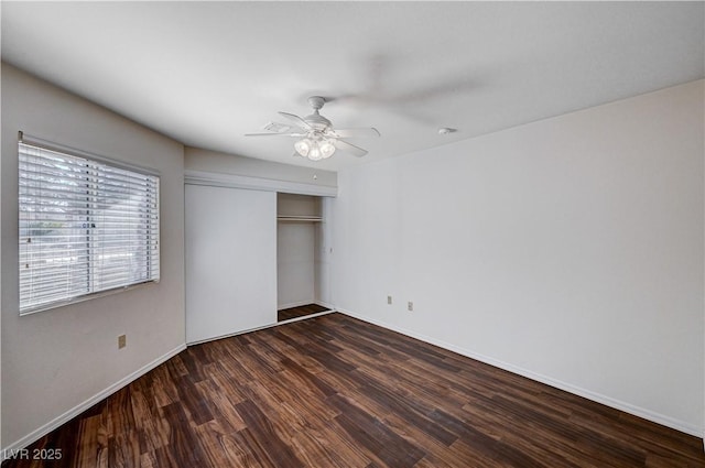 unfurnished bedroom with dark wood-type flooring, ceiling fan, and a closet