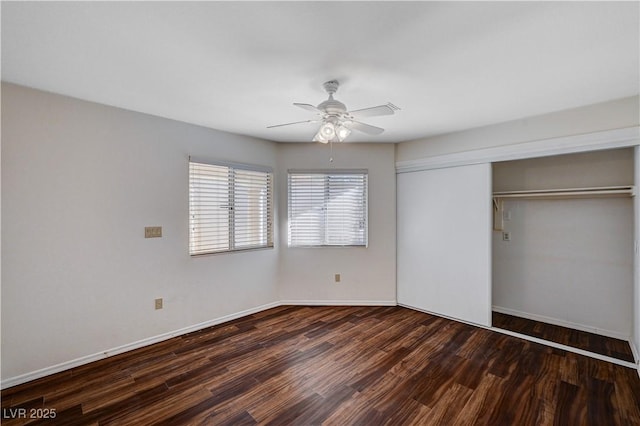 unfurnished bedroom with dark wood-type flooring, a closet, and ceiling fan