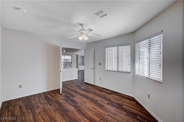 spare room with ceiling fan and dark hardwood / wood-style flooring