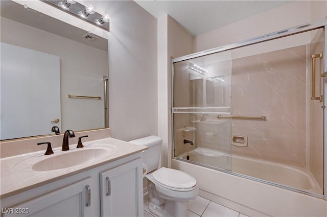 full bathroom with vanity, tile patterned floors, shower / bath combination with glass door, and toilet