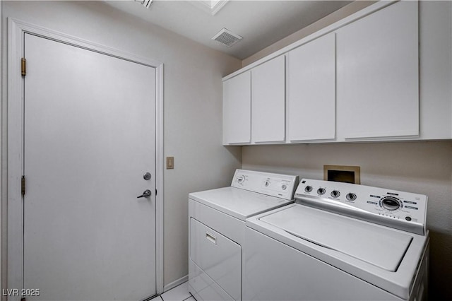 washroom featuring cabinets and washer and dryer