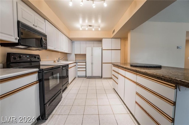 kitchen featuring light tile patterned flooring, rail lighting, sink, white cabinets, and black appliances