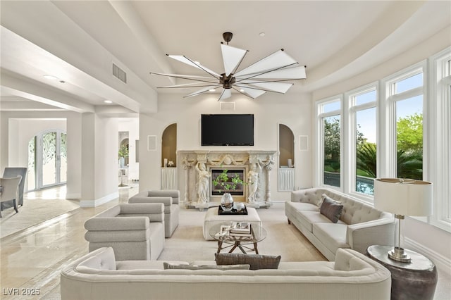 1549 Foothills Village Dr, Henderson, NV 89012 - living room with a fireplace, arched walkways, marble finish floor, baseboards, and visible vents