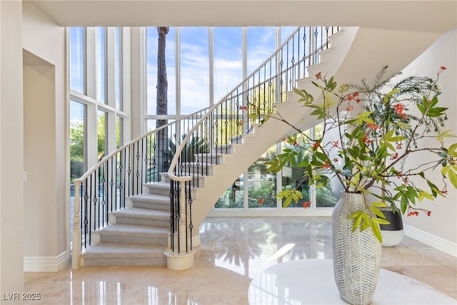 1549 Foothills Village Dr, Henderson, NV 89012 - stairway featuring baseboards, marble finish floor, and a wealth of natural light