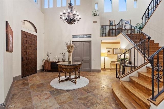 entrance foyer with a chandelier and a high ceiling