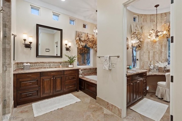 bathroom with vanity, a bathing tub, and crown molding