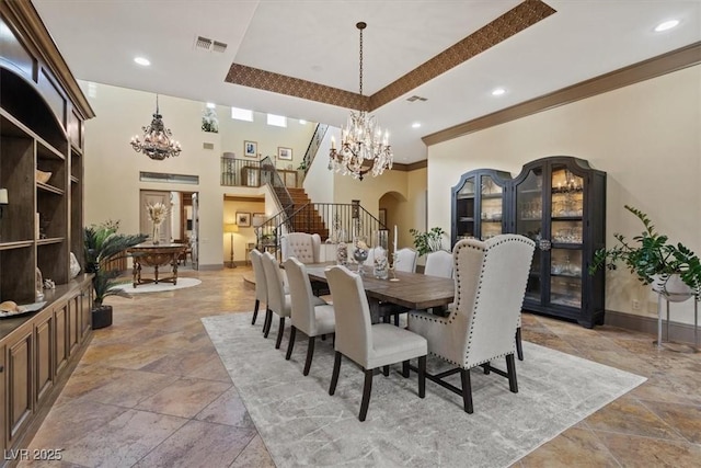 dining space featuring crown molding, a chandelier, and a tray ceiling