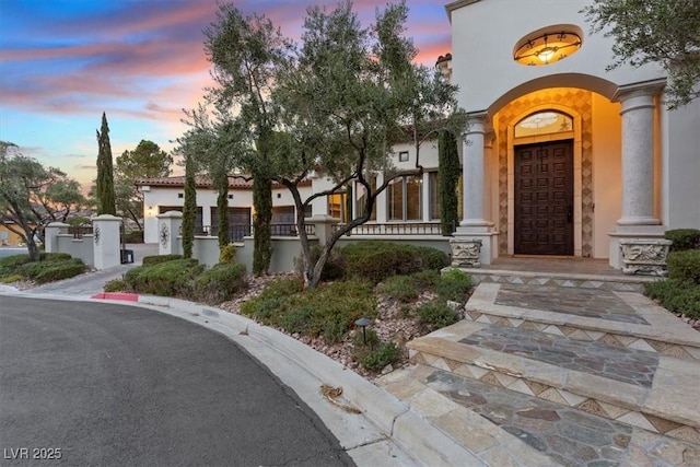 view of exterior entry at dusk