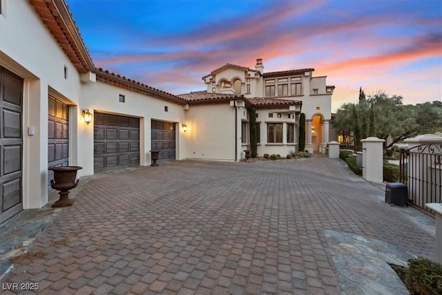 mediterranean / spanish house with a garage