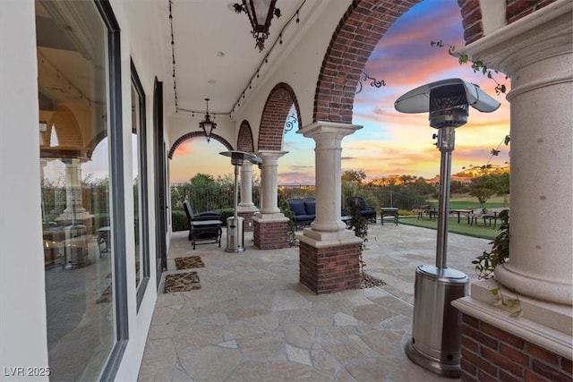 view of patio terrace at dusk