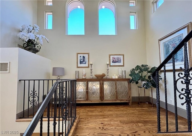 interior space with hardwood / wood-style floors and a high ceiling