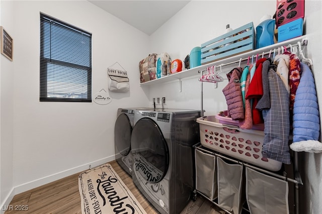 laundry room with hardwood / wood-style flooring and washer and clothes dryer