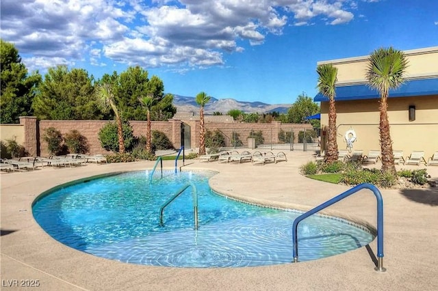 view of pool with a mountain view and a patio area