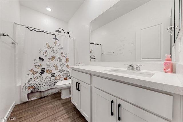 full bathroom featuring vanity, hardwood / wood-style floors, shower / tub combo, and toilet