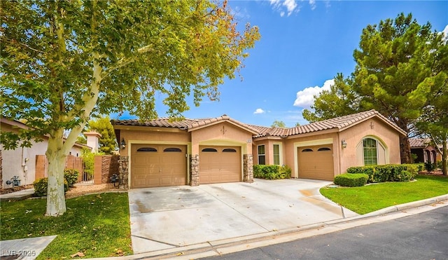 mediterranean / spanish-style home featuring a garage and a front yard