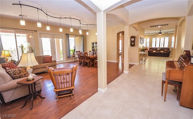 living room featuring ceiling fan and light wood-type flooring