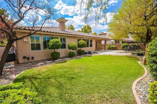 back of property featuring a yard, a patio, and central air condition unit