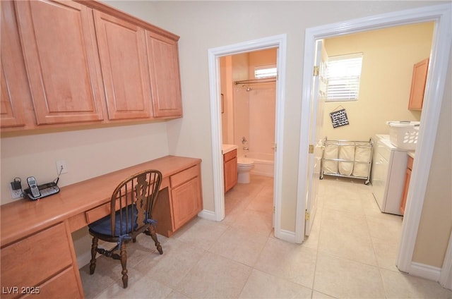 tiled office space with independent washer and dryer and built in desk