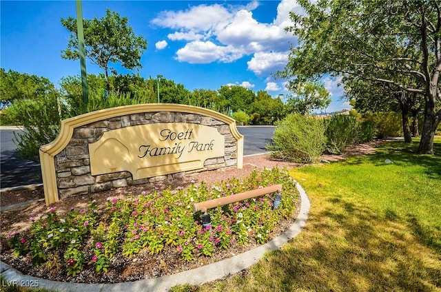 community / neighborhood sign with a yard