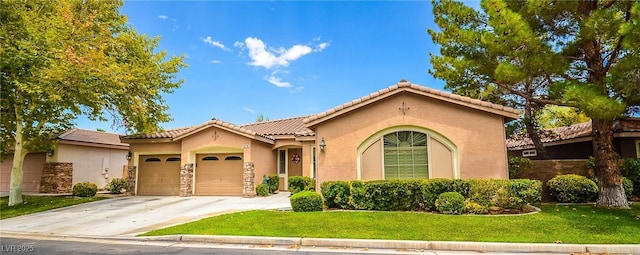 mediterranean / spanish-style home featuring a garage and a front yard