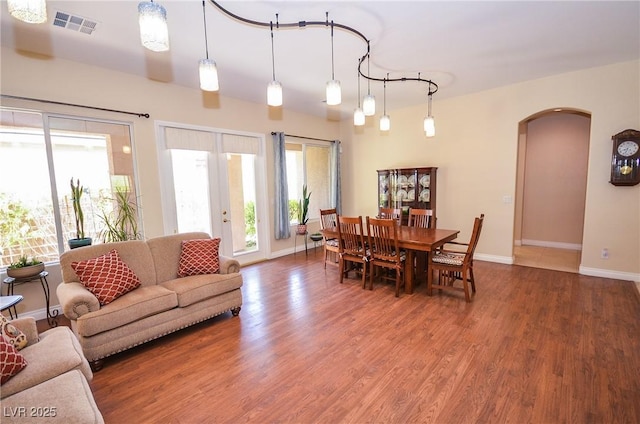 living room with hardwood / wood-style flooring, a wealth of natural light, and french doors