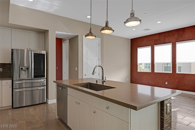 kitchen with sink, stainless steel appliances, wine cooler, an island with sink, and decorative light fixtures