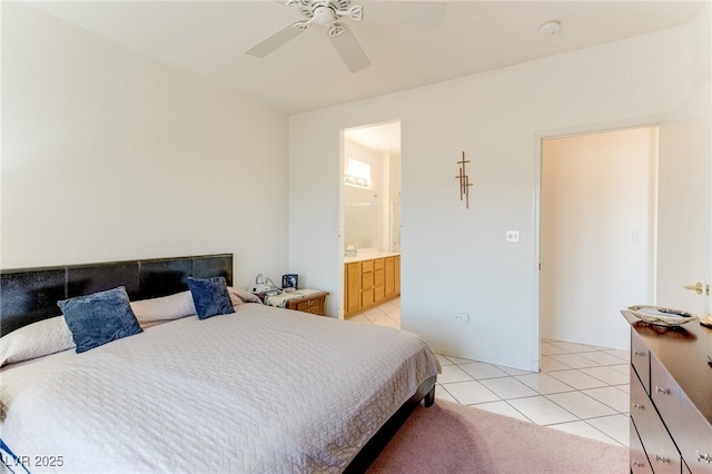 bedroom with light tile patterned flooring, ensuite bathroom, and ceiling fan