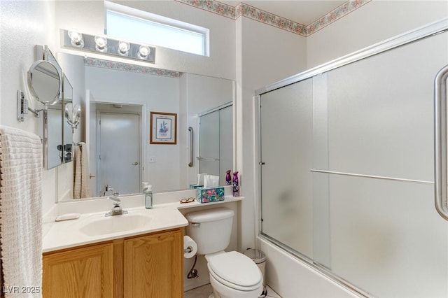 full bathroom with vanity, toilet, and combined bath / shower with glass door