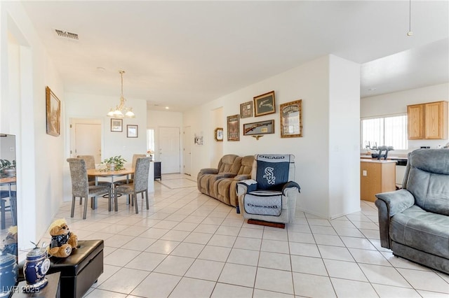 tiled living room featuring a chandelier