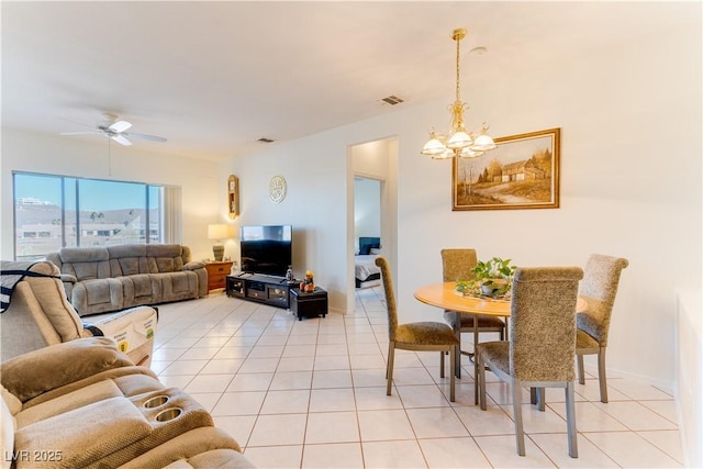 dining area featuring light tile patterned floors and ceiling fan with notable chandelier